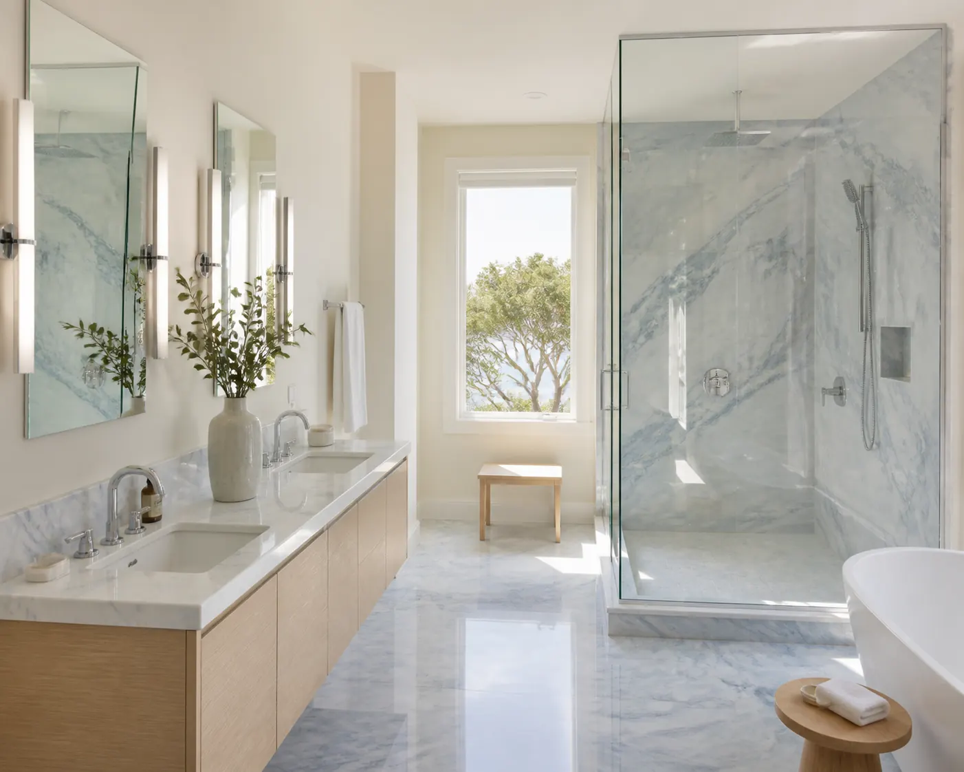 Belvedere bathroom in blue-gray marble with a glass shower and light oak double vanity
