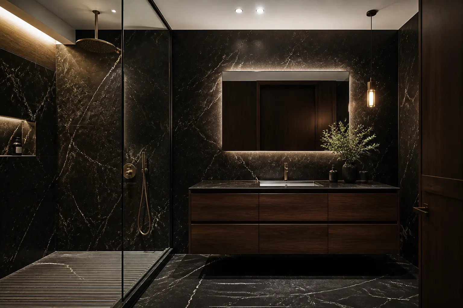 Dark bathroom with black marble walls, walnut vanity and backlit mirror