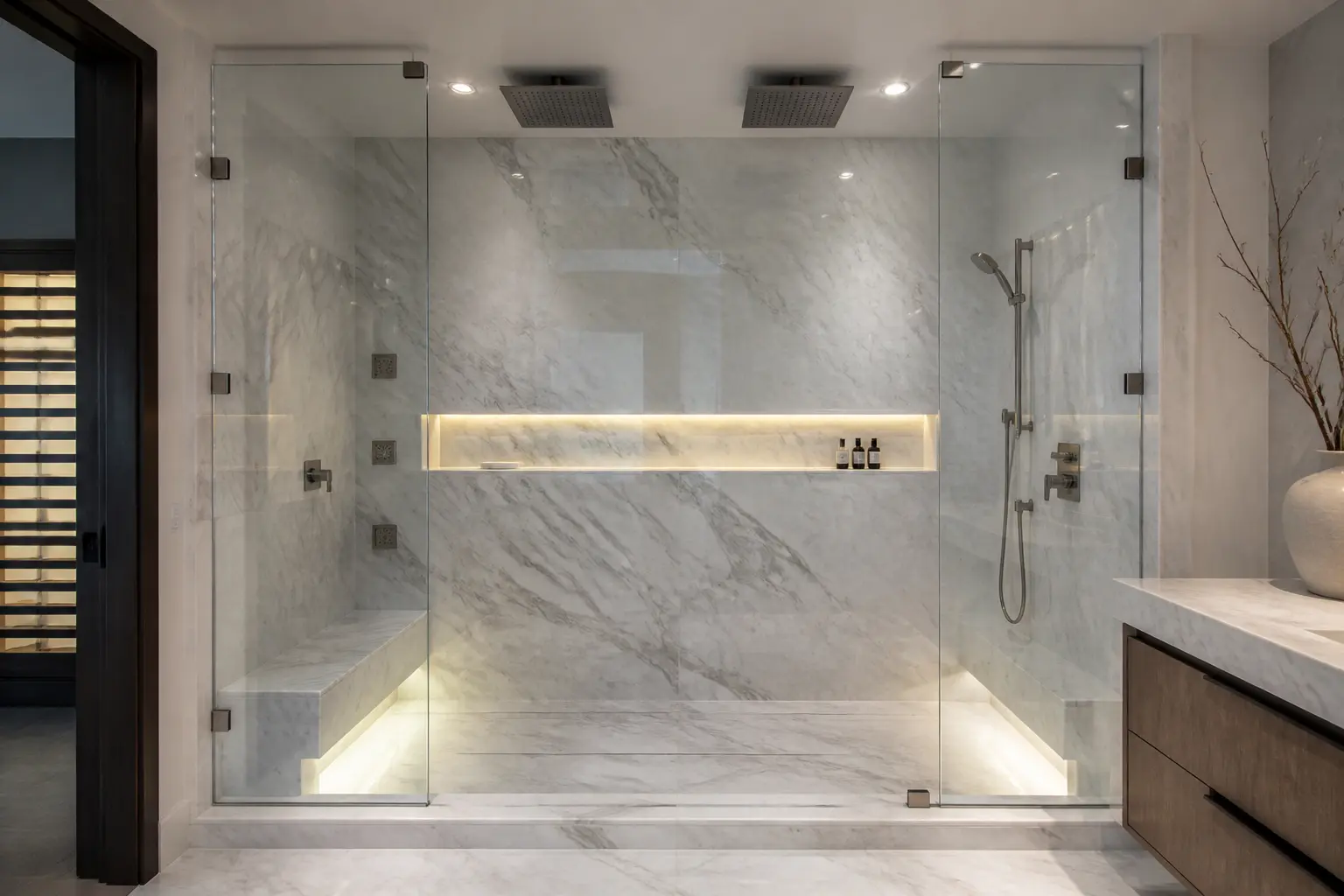 Beverly Hills marble steam shower with dual rainheads, bench and lit niche